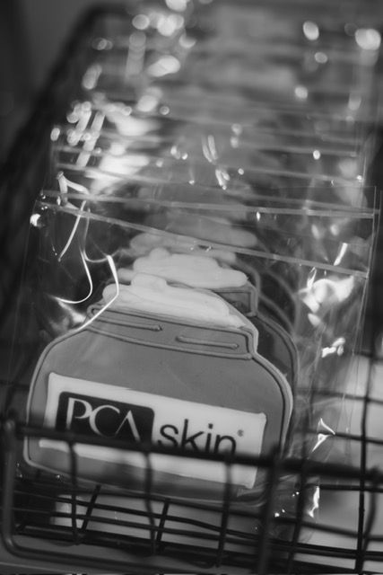 Stacked cookies shaped like cream jars with the 