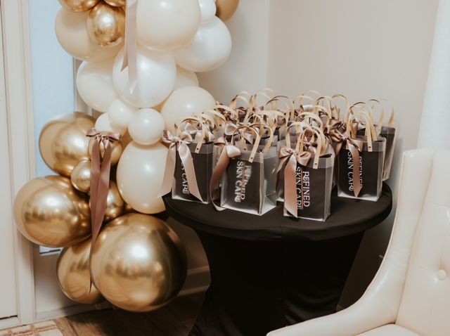 A black table holds gift bags labeled 