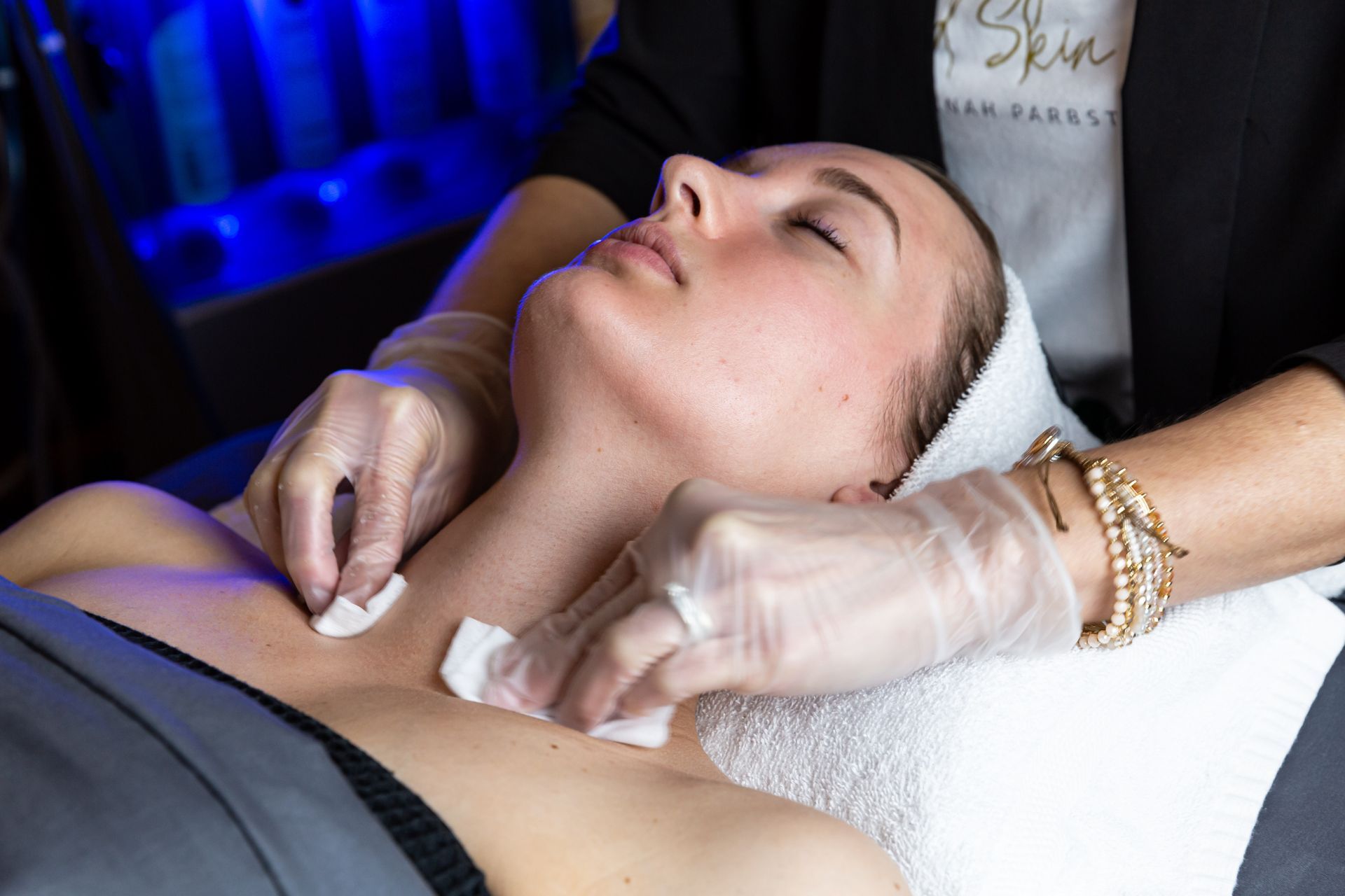 A woman is getting a facial treatment at a spa.