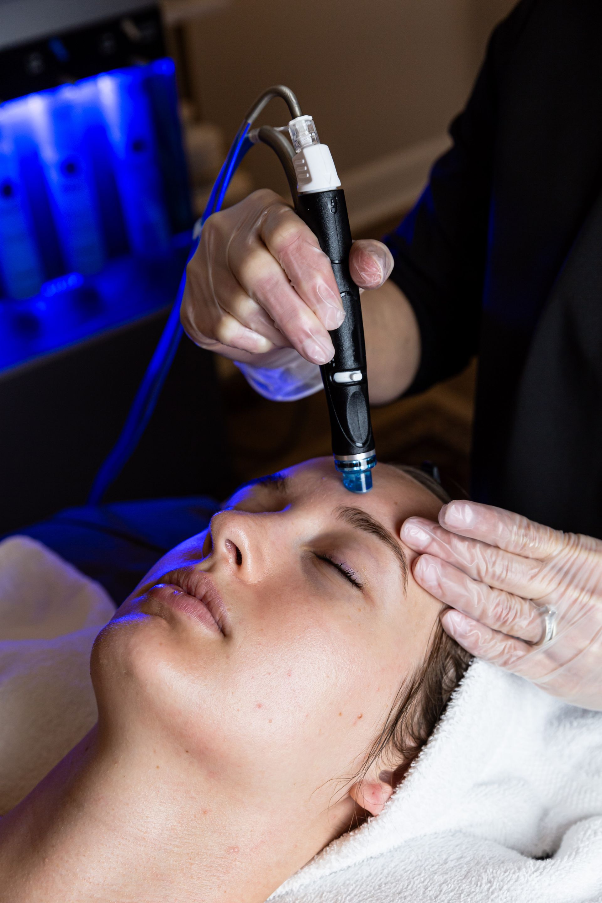 A woman is getting a facial treatment at a spa.