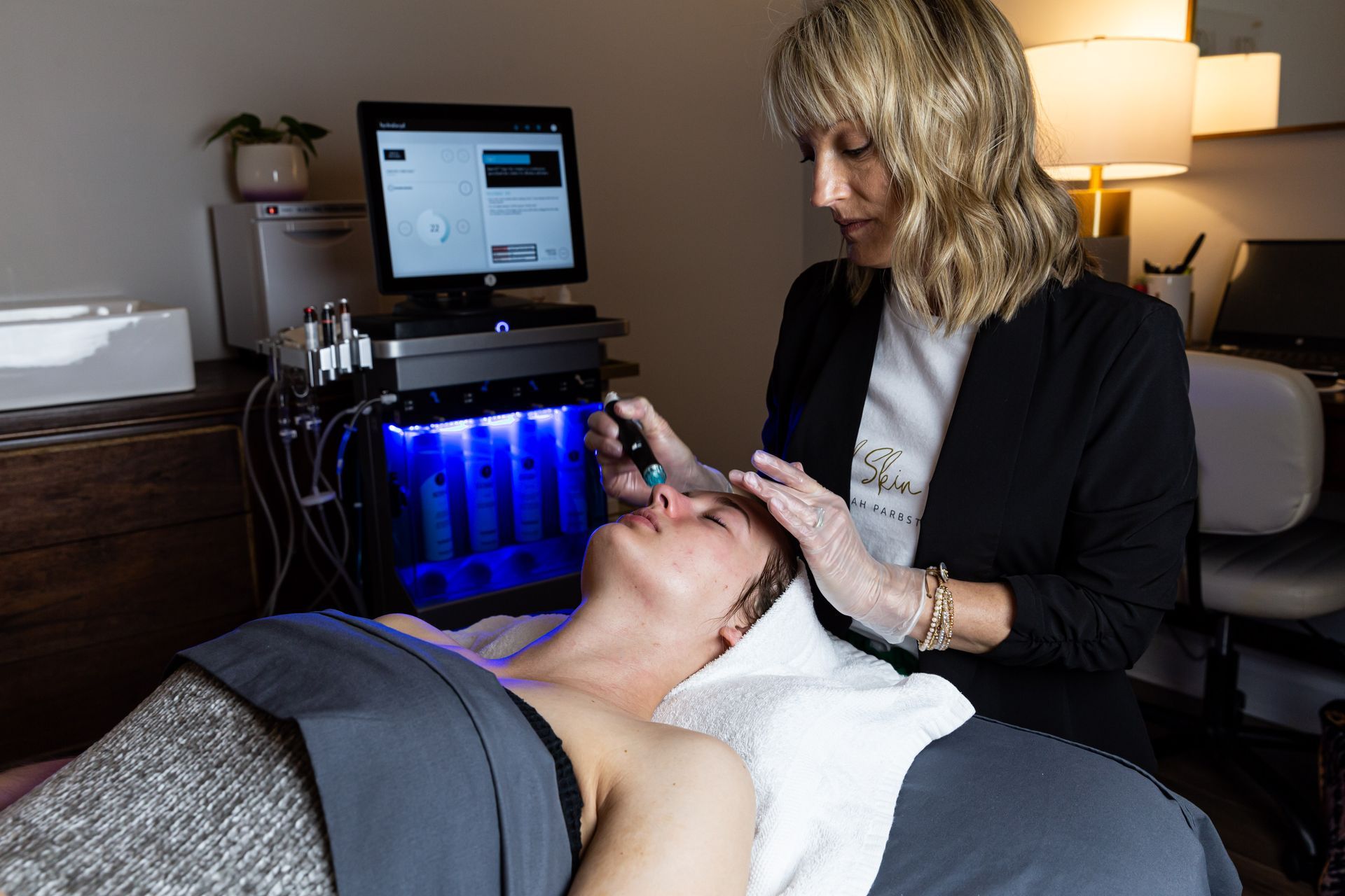 A woman is getting a facial treatment at a beauty salon.