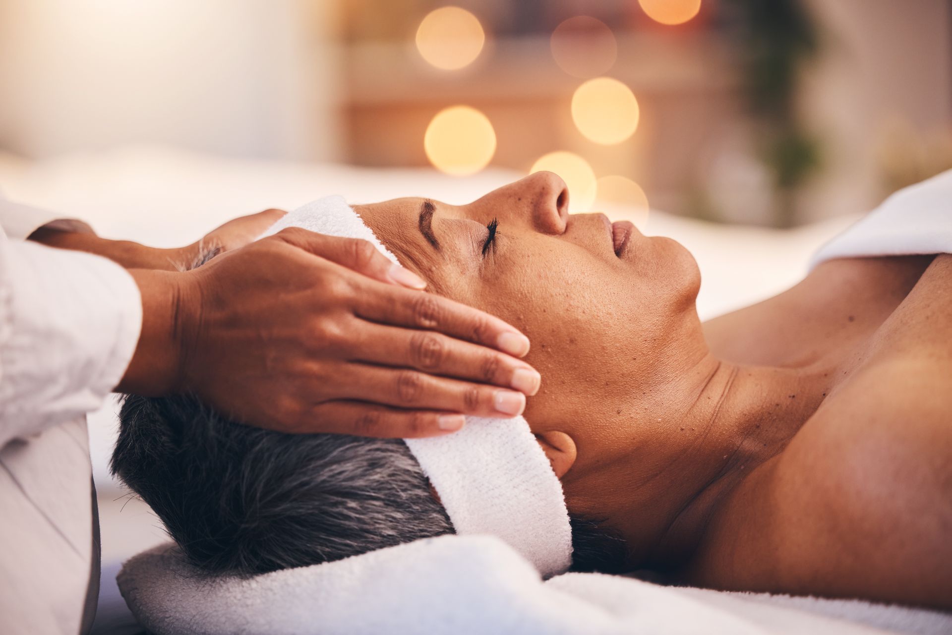 A man is getting a head massage at a spa.