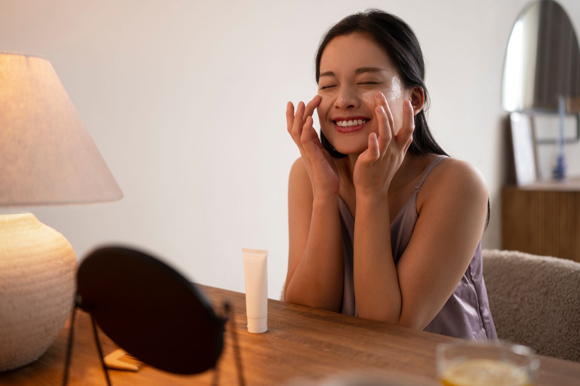 woman putting on face cream
