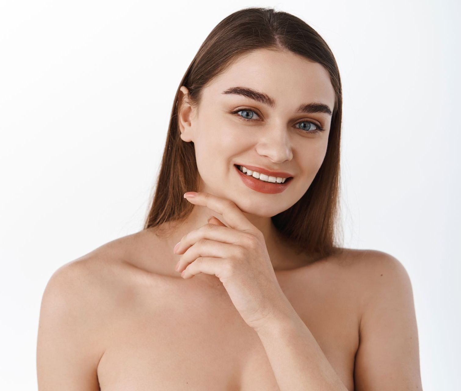A portrait of a person with long hair and visible freckles against a neutral white background.