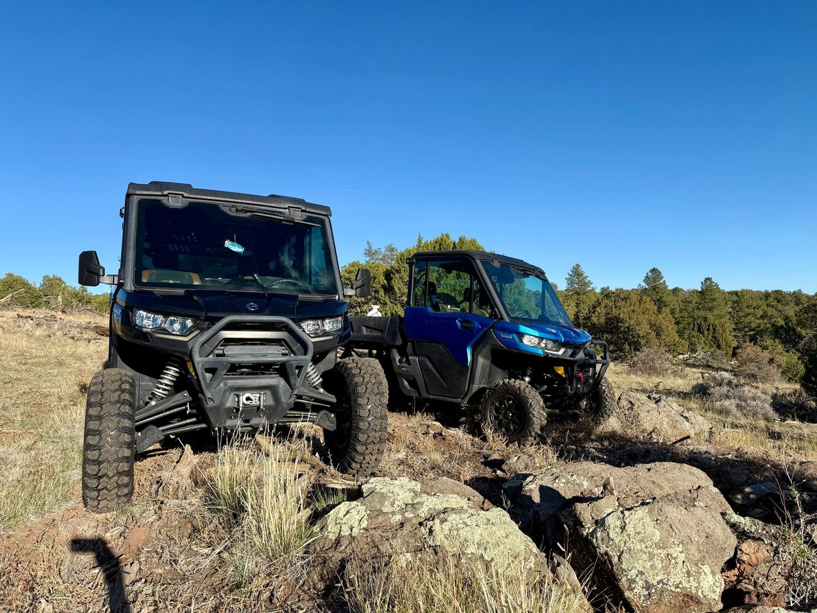 Green Can-Am Defender side-by-side utility vehicle.
