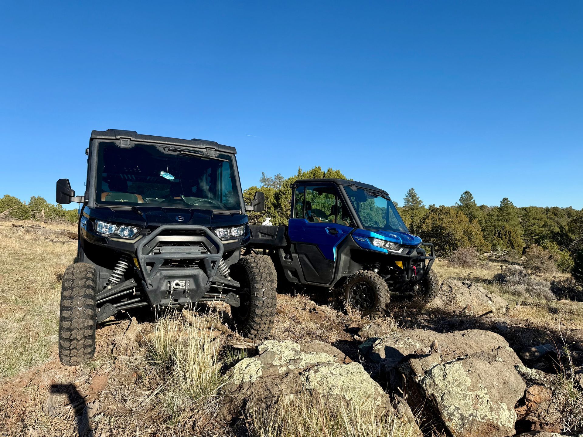 Green Can-Am Defender side-by-side utility vehicle.