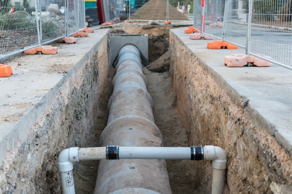 A Construction Site with A Large Pipe in A Trench — Barry Brown Rural Contracting Service in Gloucester, NSW