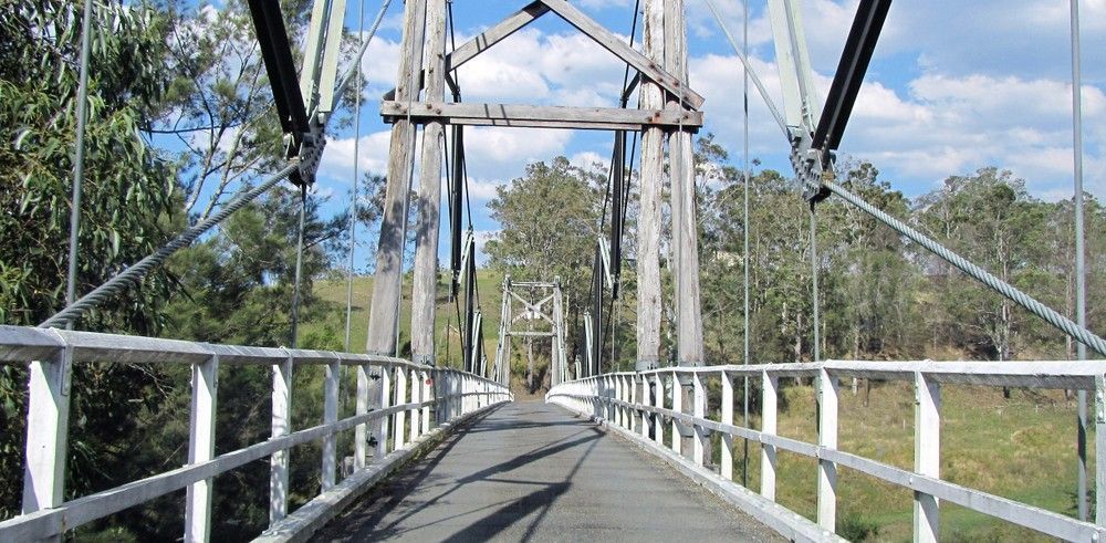 A Wooden Suspension Bridge Over a Road — Barry Brown Rural Contracting Service in Wingham, NSW