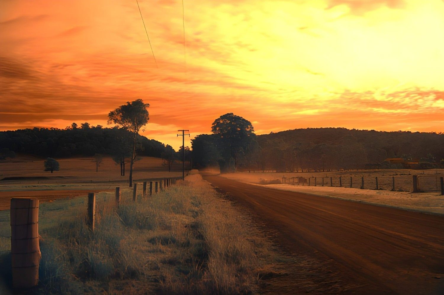 A Dirt Road Through Countryside at Sunset — Barry Brown Rural Contracting Service in Nabiac, NSW