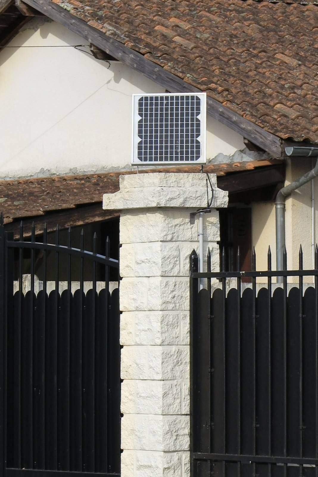 A Solar Panel on A Stone Pillar Above a Fence — Barry Brown Rural Contracting Service in Forster, NSW
