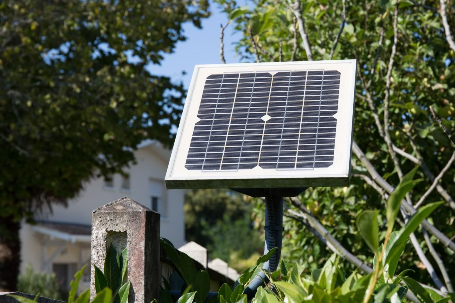 A Solar Panel Mounted on A Post in Front of A House — Barry Brown Rural Contracting Service in Wingham, NSW