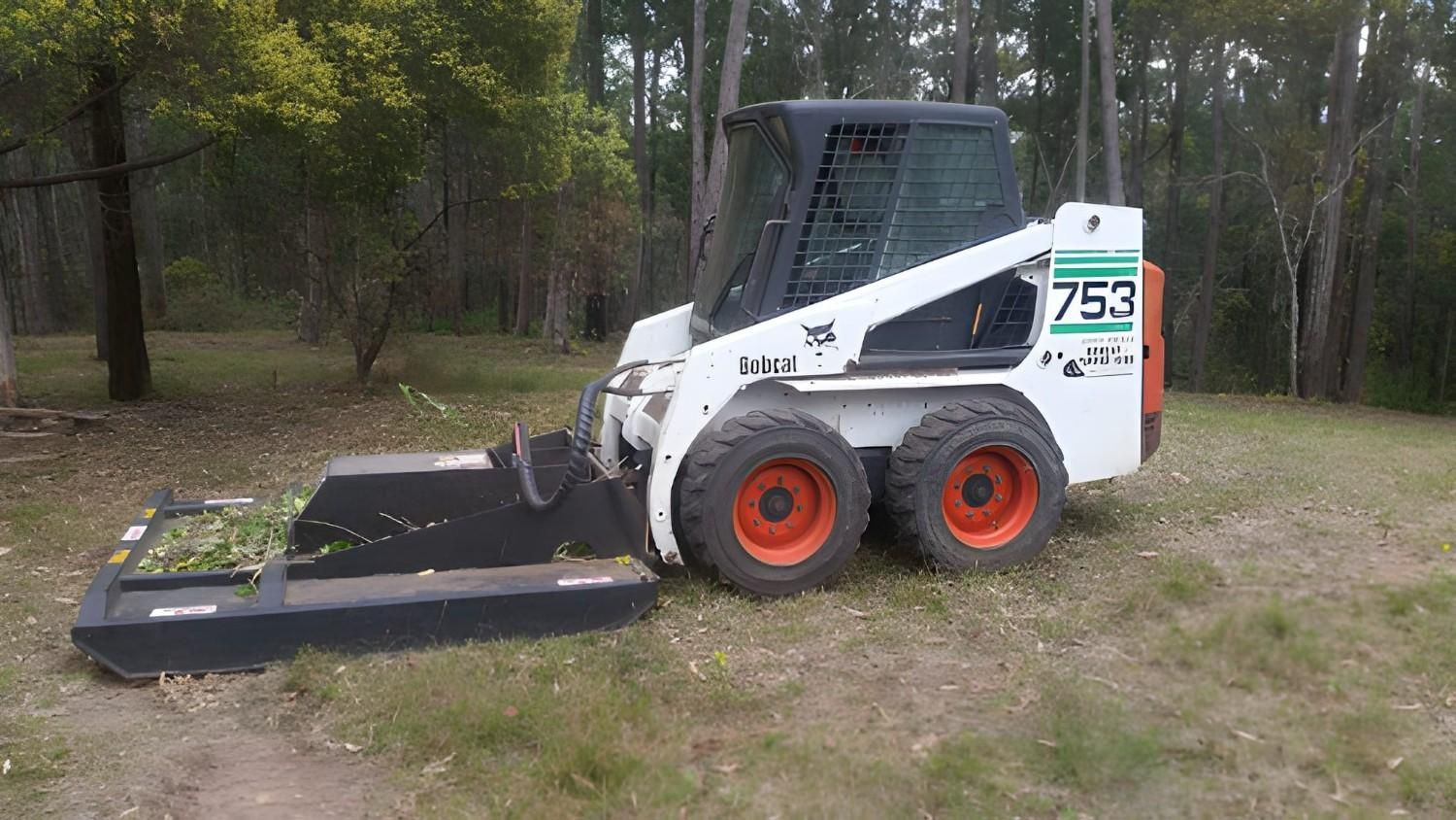 A Bobcat Skid Steer with A Brush Cutter Attachment — Barry Brown Rural Contracting Service in Tinonee, NSW