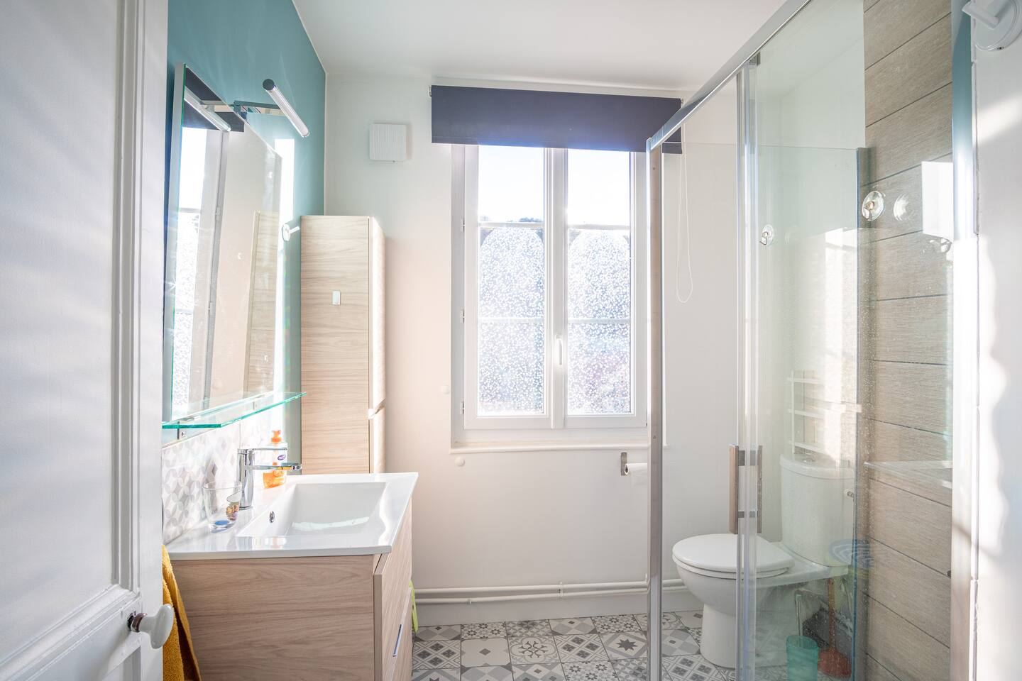 Une salle de bain avec lavabo, WC et douche.