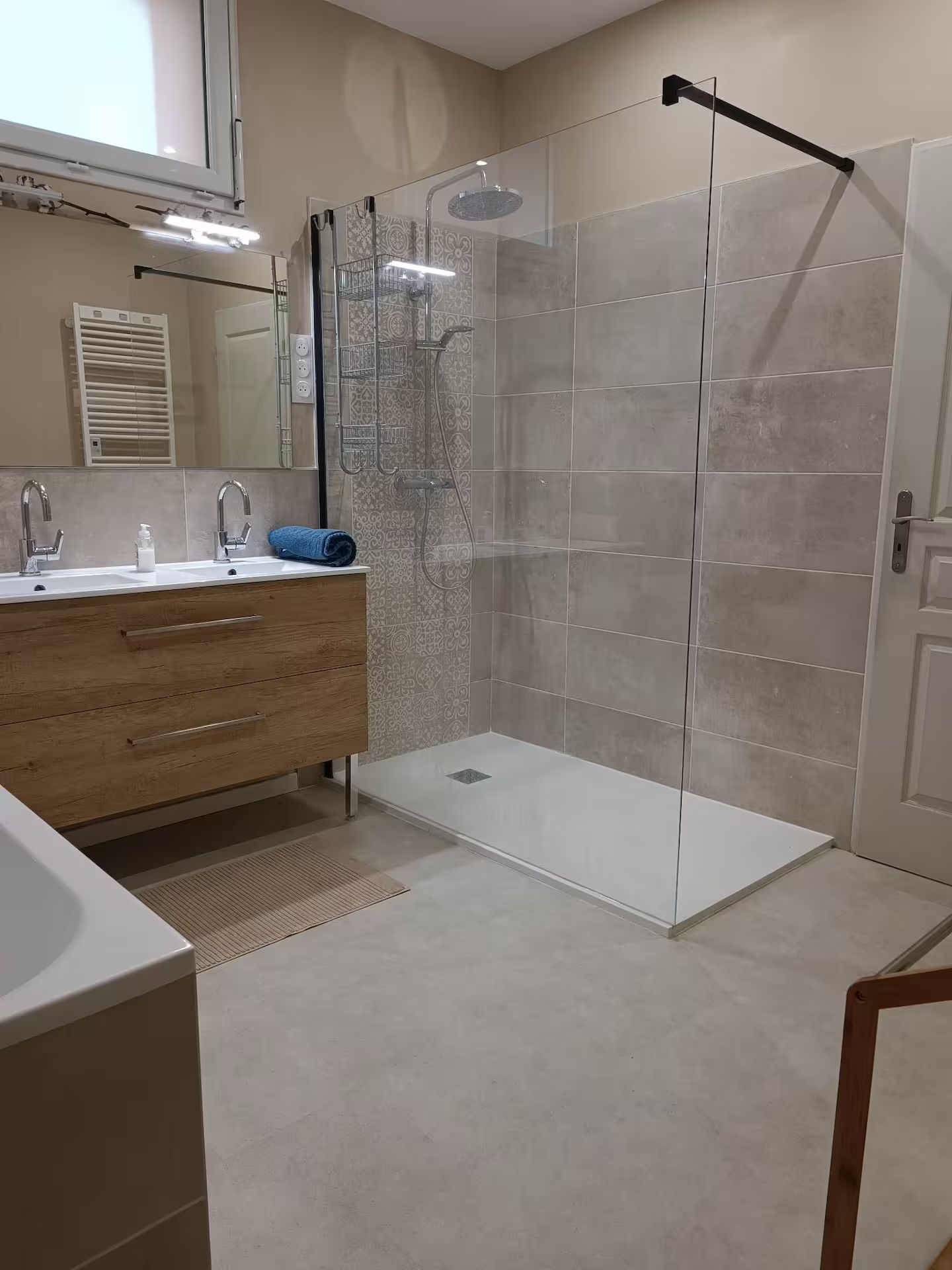 Une salle de bain avec deux vasques et une douche à l'italienne.