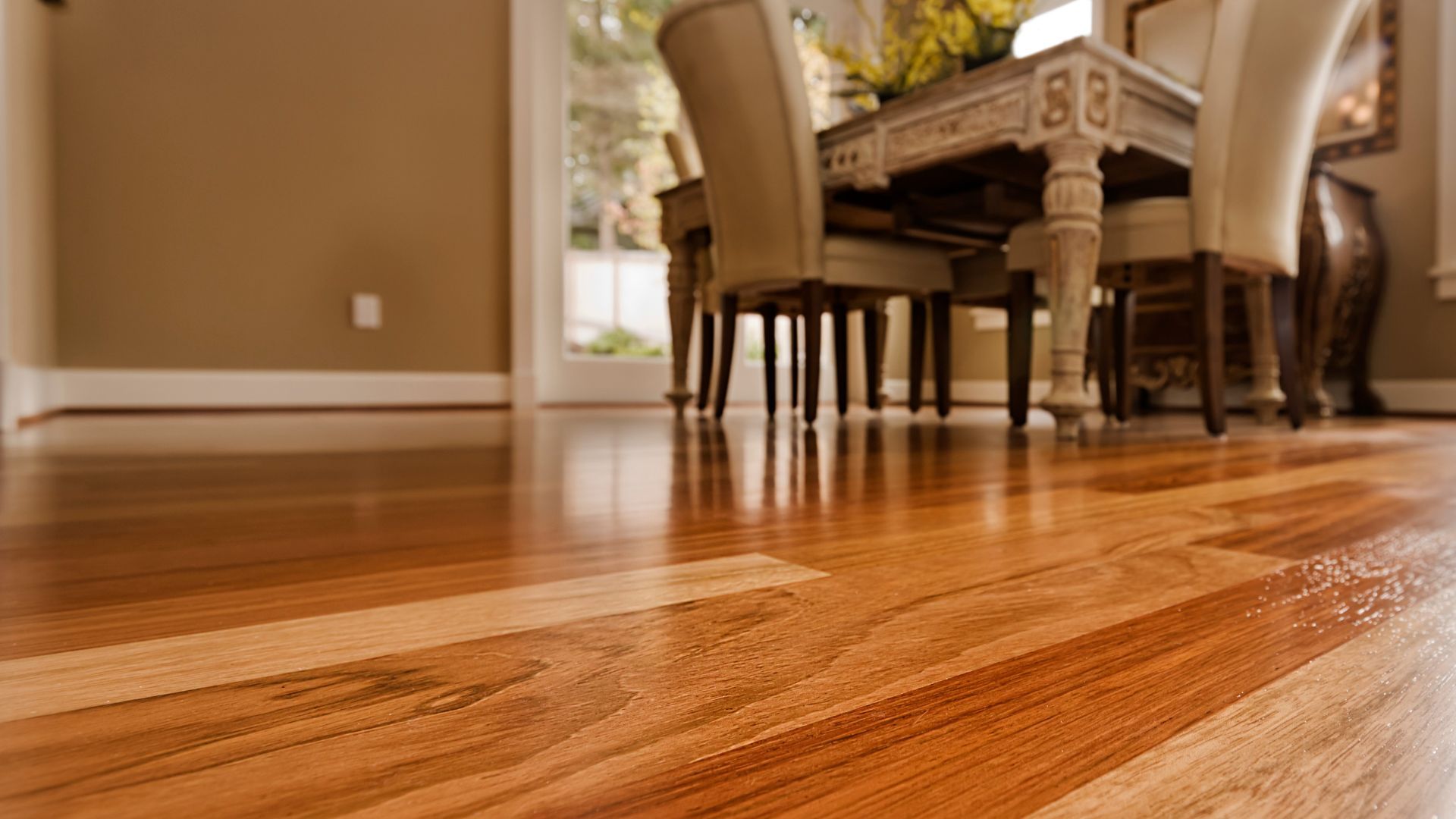 Gleaming hardwood floor with a hint of an elegant dining set.