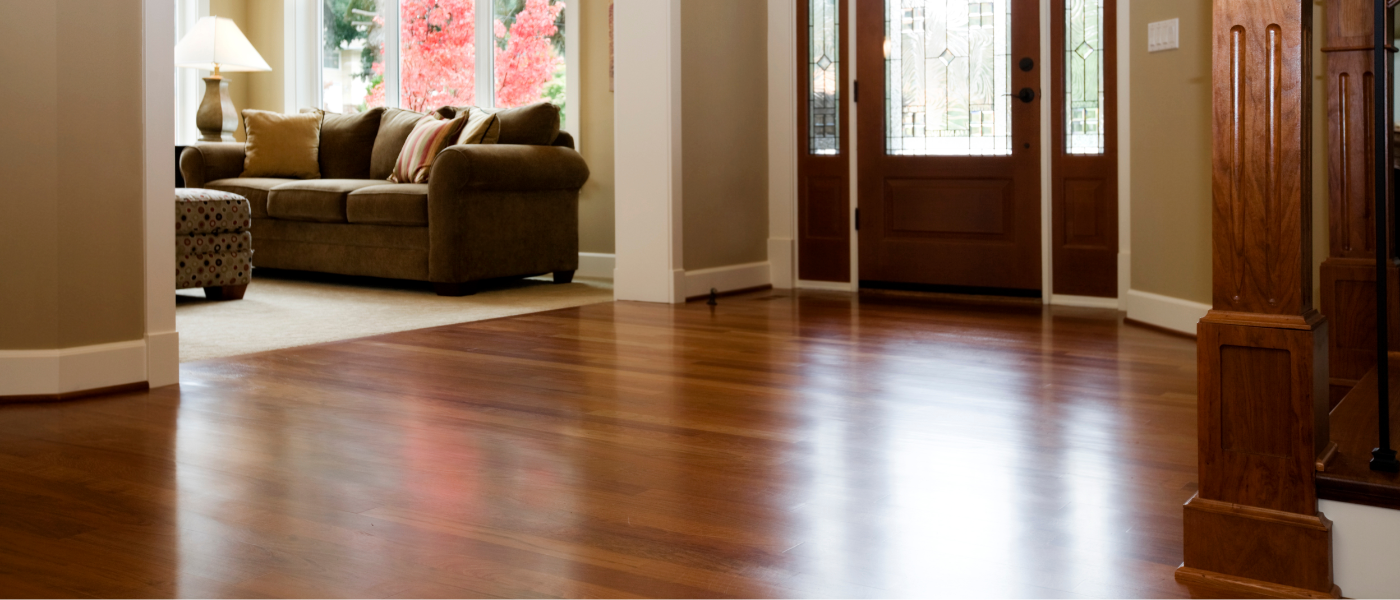 Photo of a beautiful hardwood floor in the foyer of a family's home. 