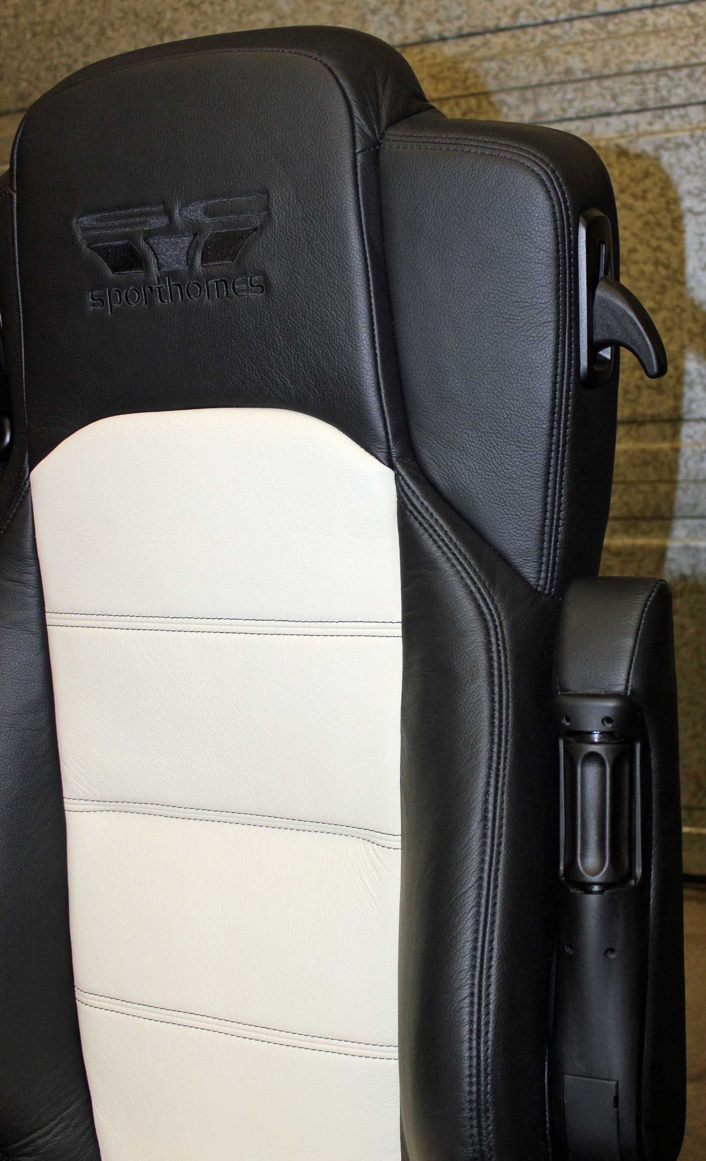 The stitching detail on the of a black and white car seat.