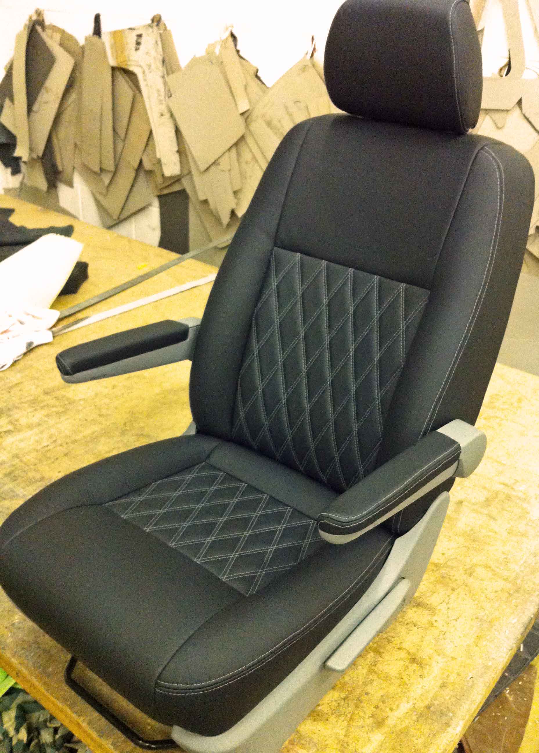 A black car seat with a diamond stitching pattern.