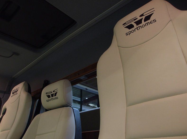 Two cream car seats with new re-upholstering.