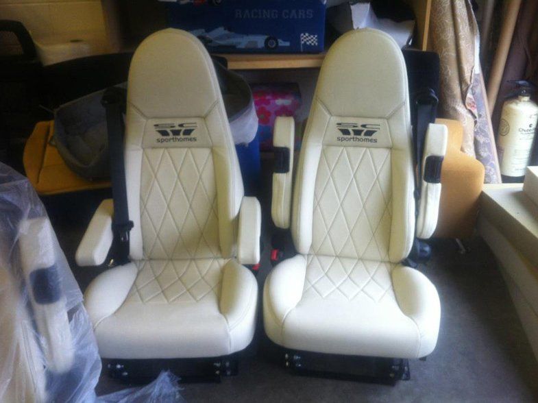 Two cream car seats that have been expertly re-upholstered.