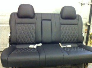 A black back car seat with a diamond stitching pattern.