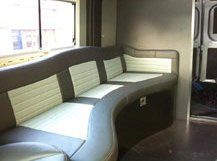 A grey and white motor home sofa with a modern curved design.
