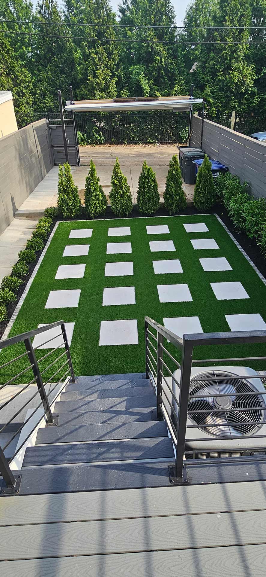 Backyard with Stairs and Green Lawn