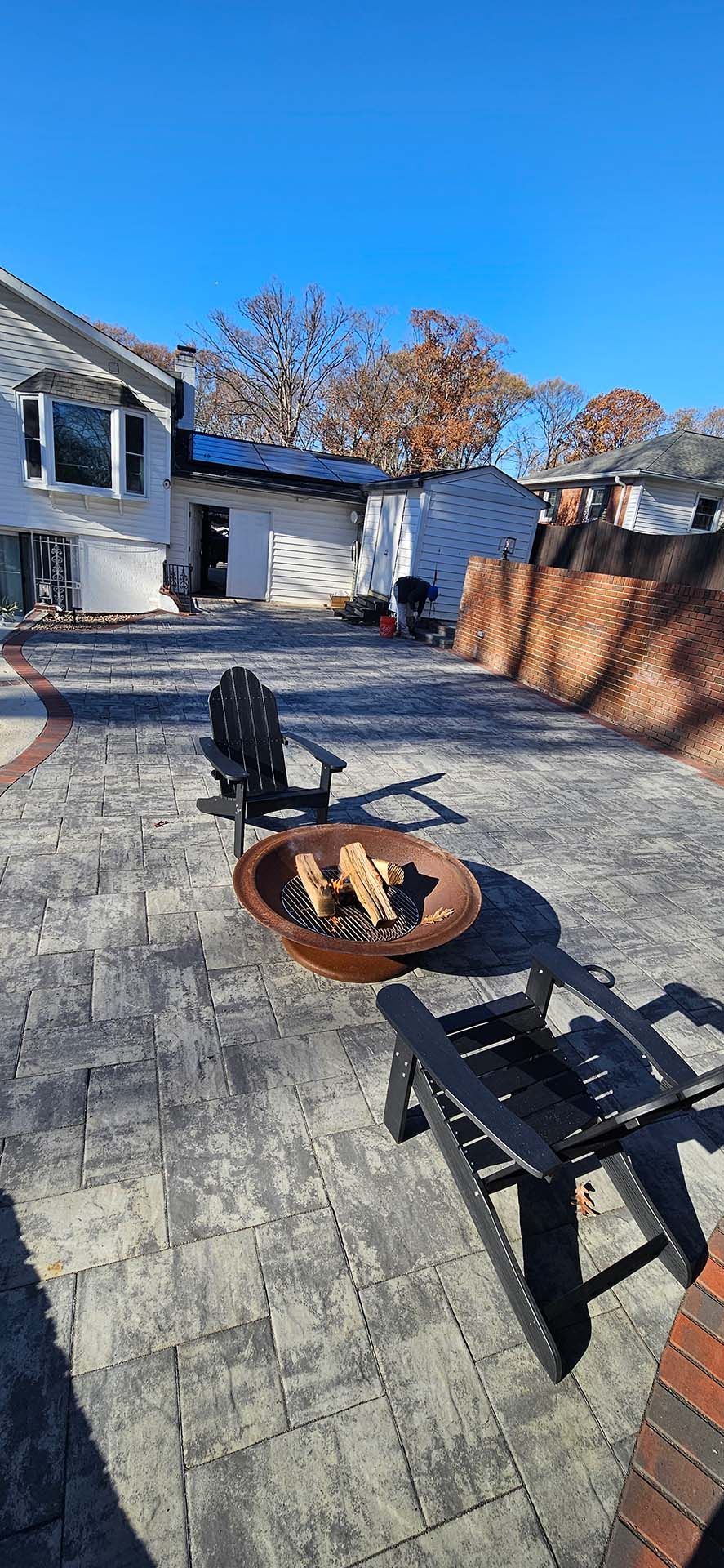 There is a fire pit in the middle of the patio.