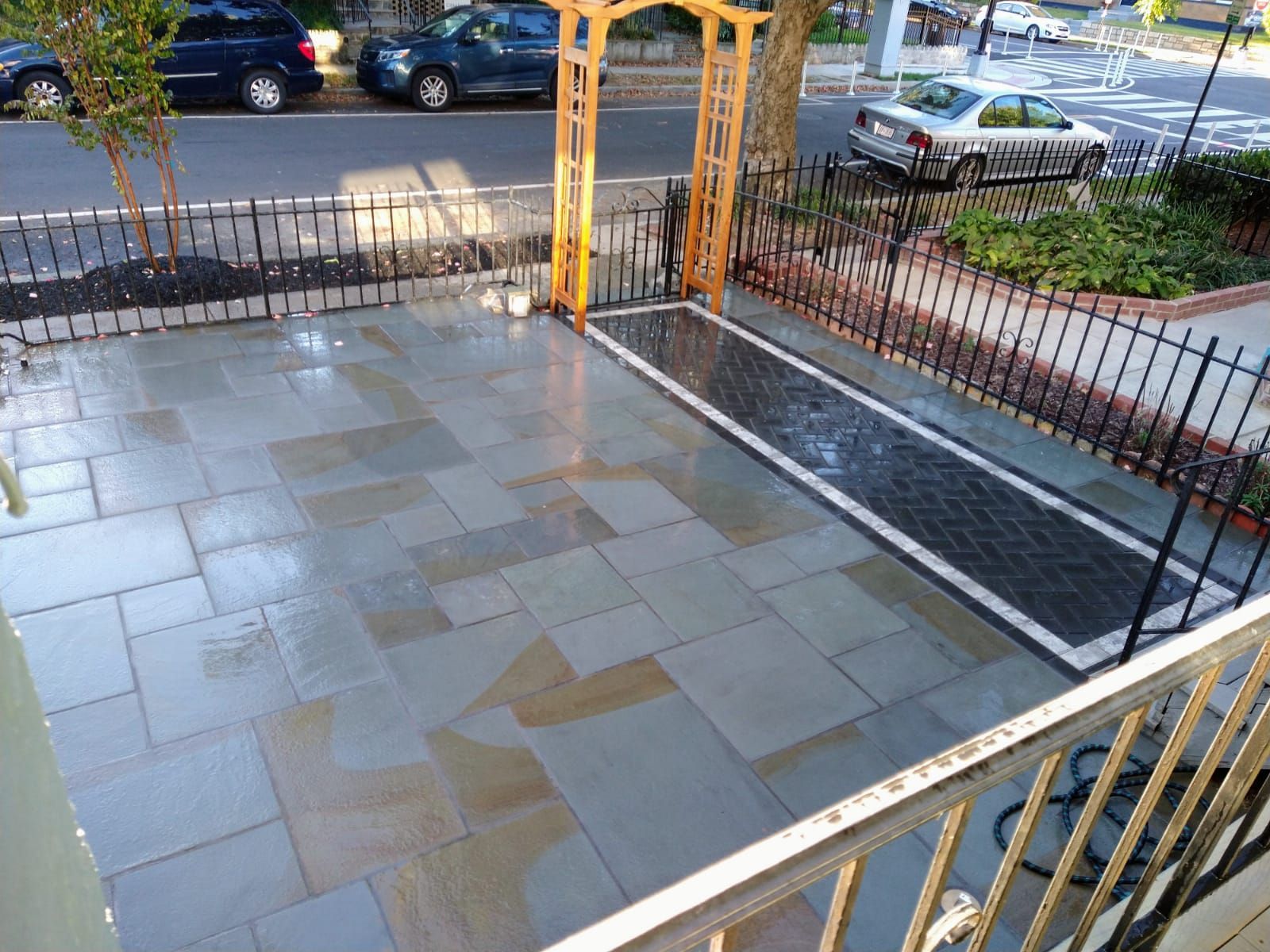 An aerial view of a patio with cars parked in the background