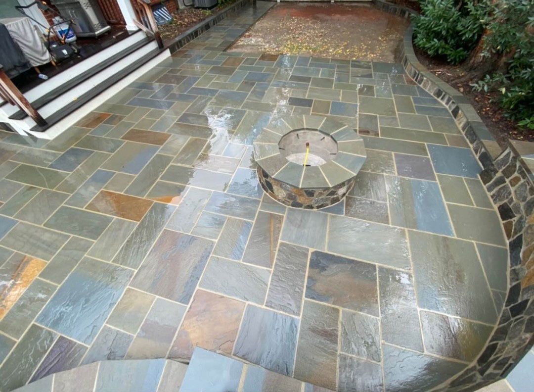 There is a fire pit in the middle of the patio.