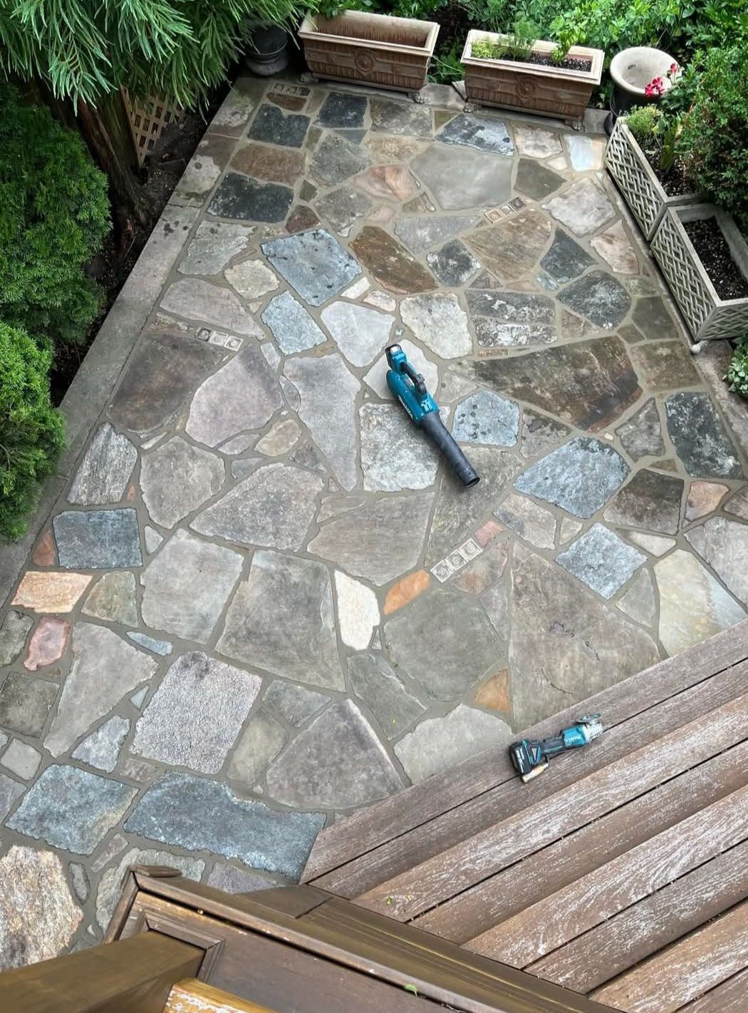 An aerial view of a stone patio with a blower on it