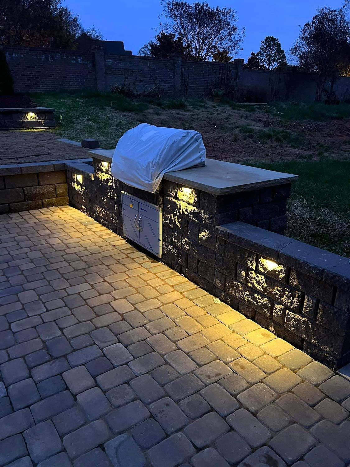 A Grill is Placed on Top of a Brick Wall