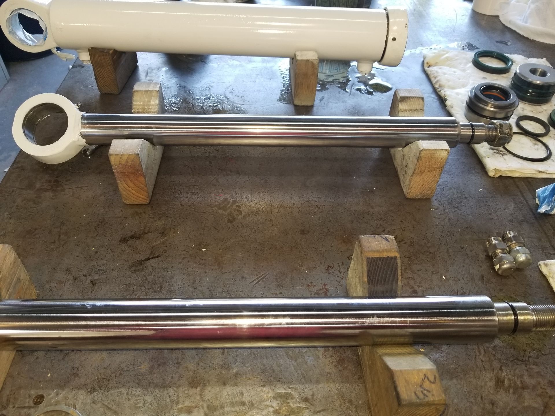 Two cylinders are sitting on wooden blocks on a table.