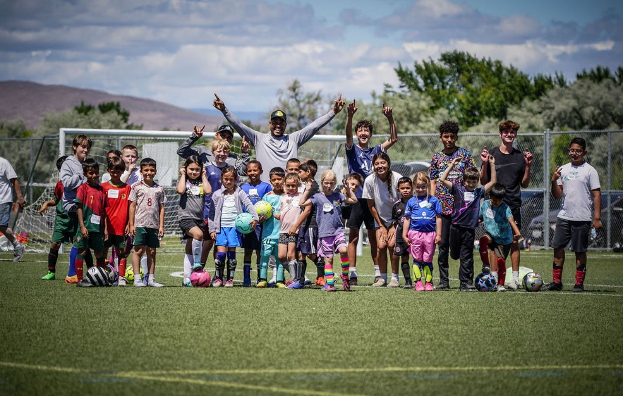 Roman Torres with Sozo soccer players