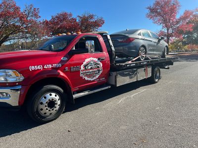 A car is being towed by a tow truck.