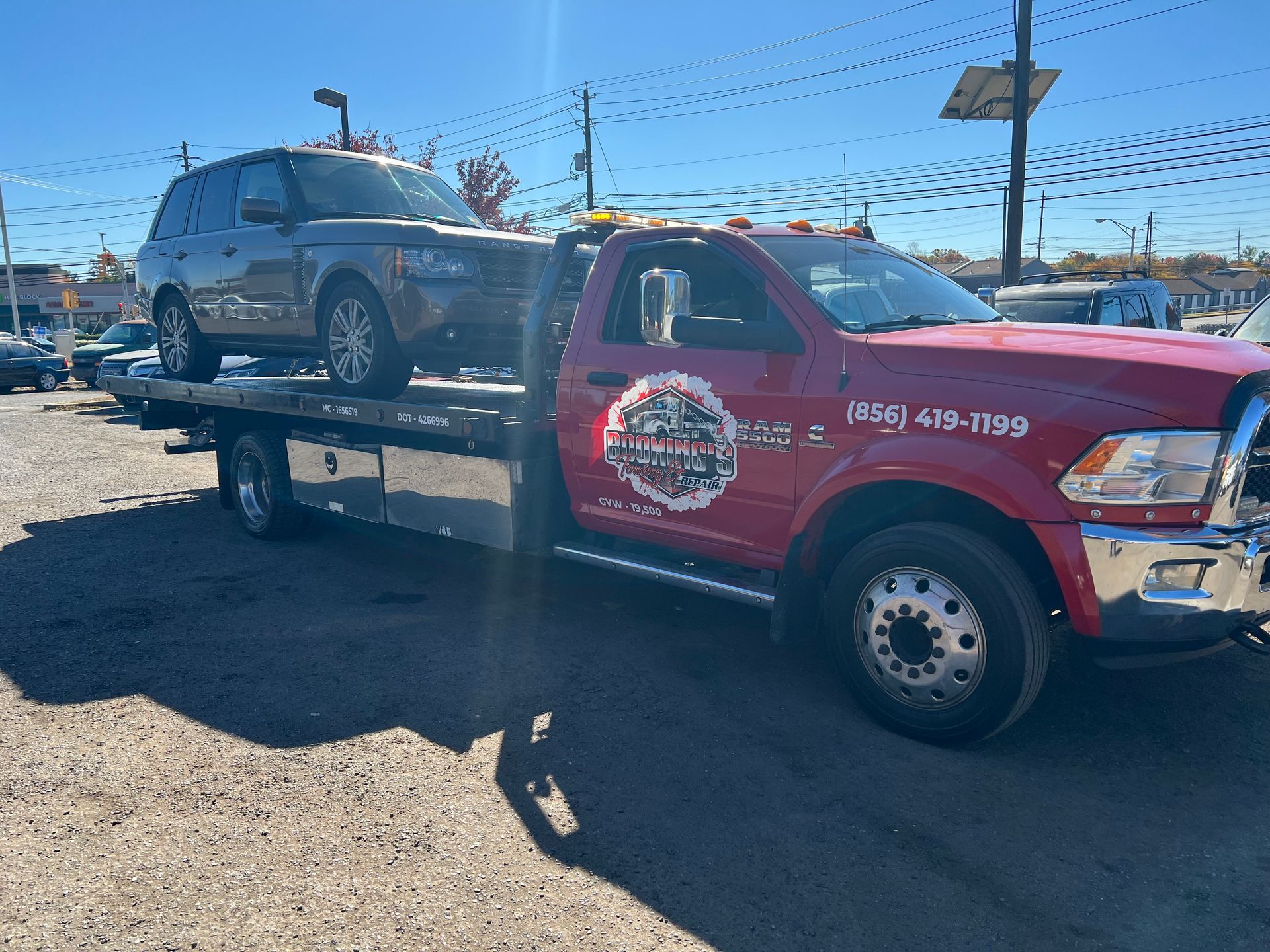 A car is being towed by a tow truck.