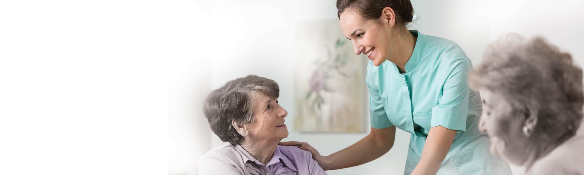 two older women having a nice conversation with young nurse
