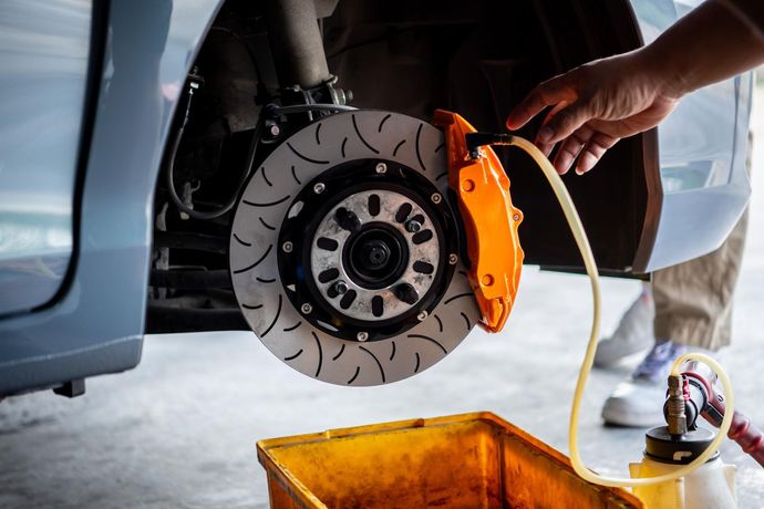 A person is fixing a brake disc on a car.