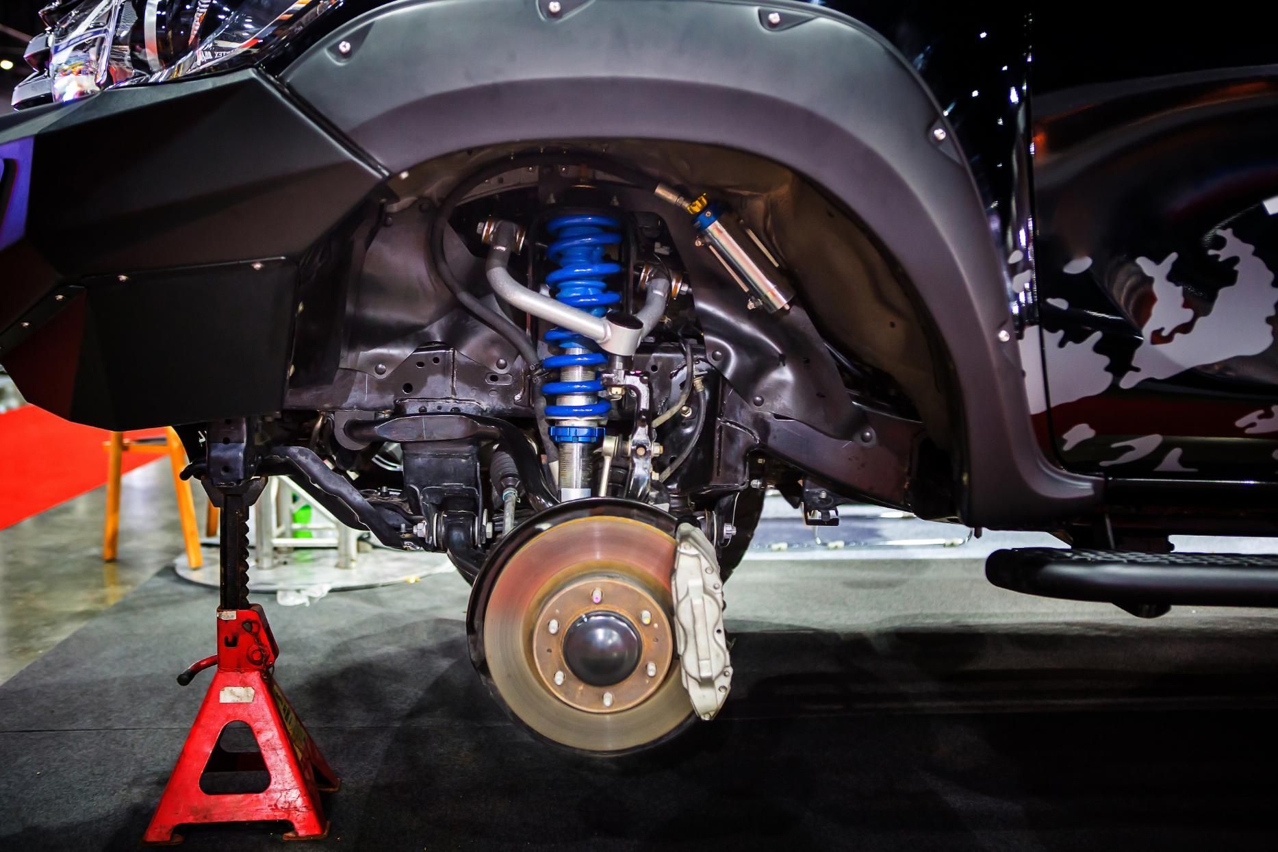 The underside of a car is being worked on.