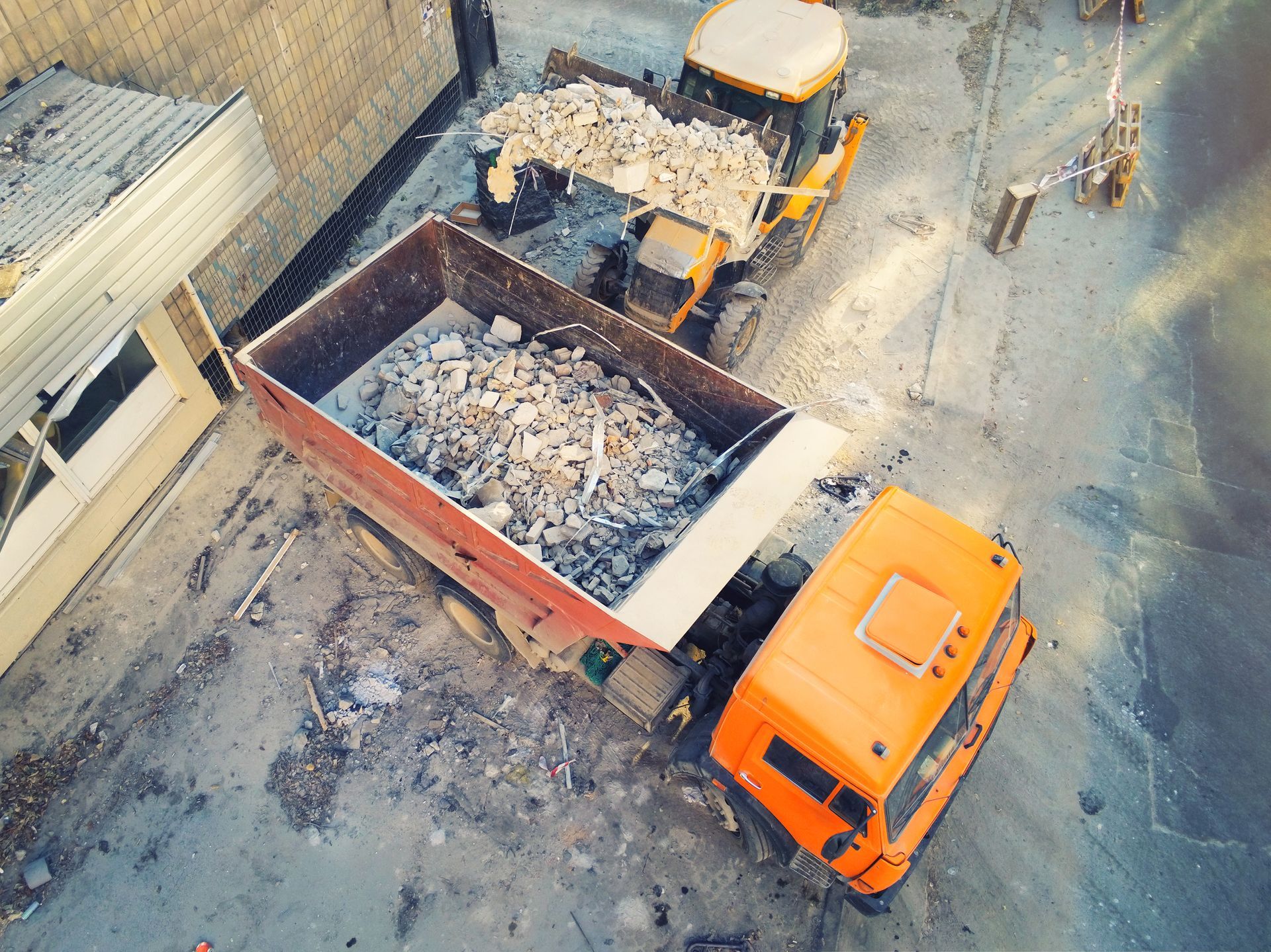 An aerial view of a dump truck filled with rocks.