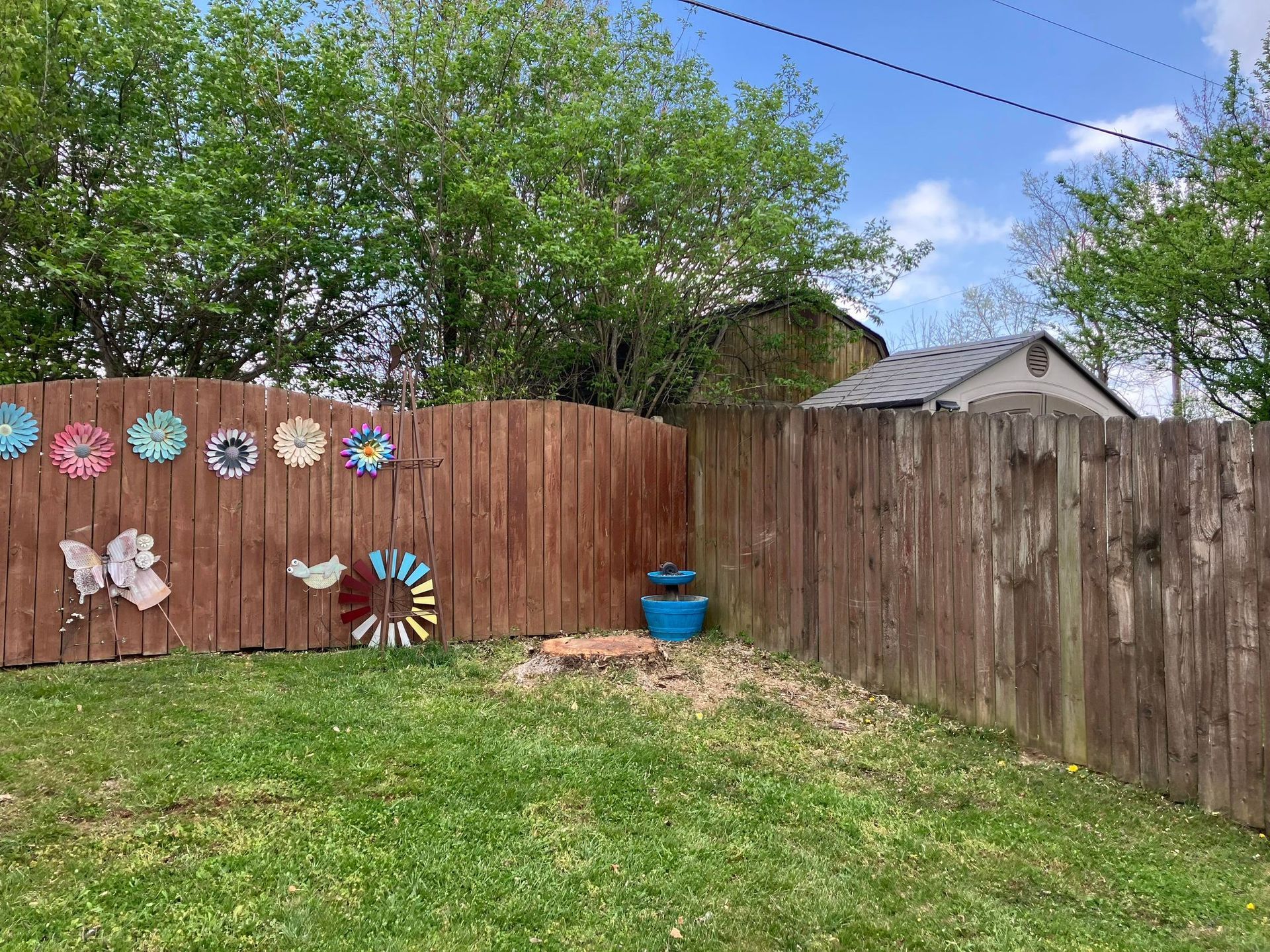 A wooden fence with flowers painted on it