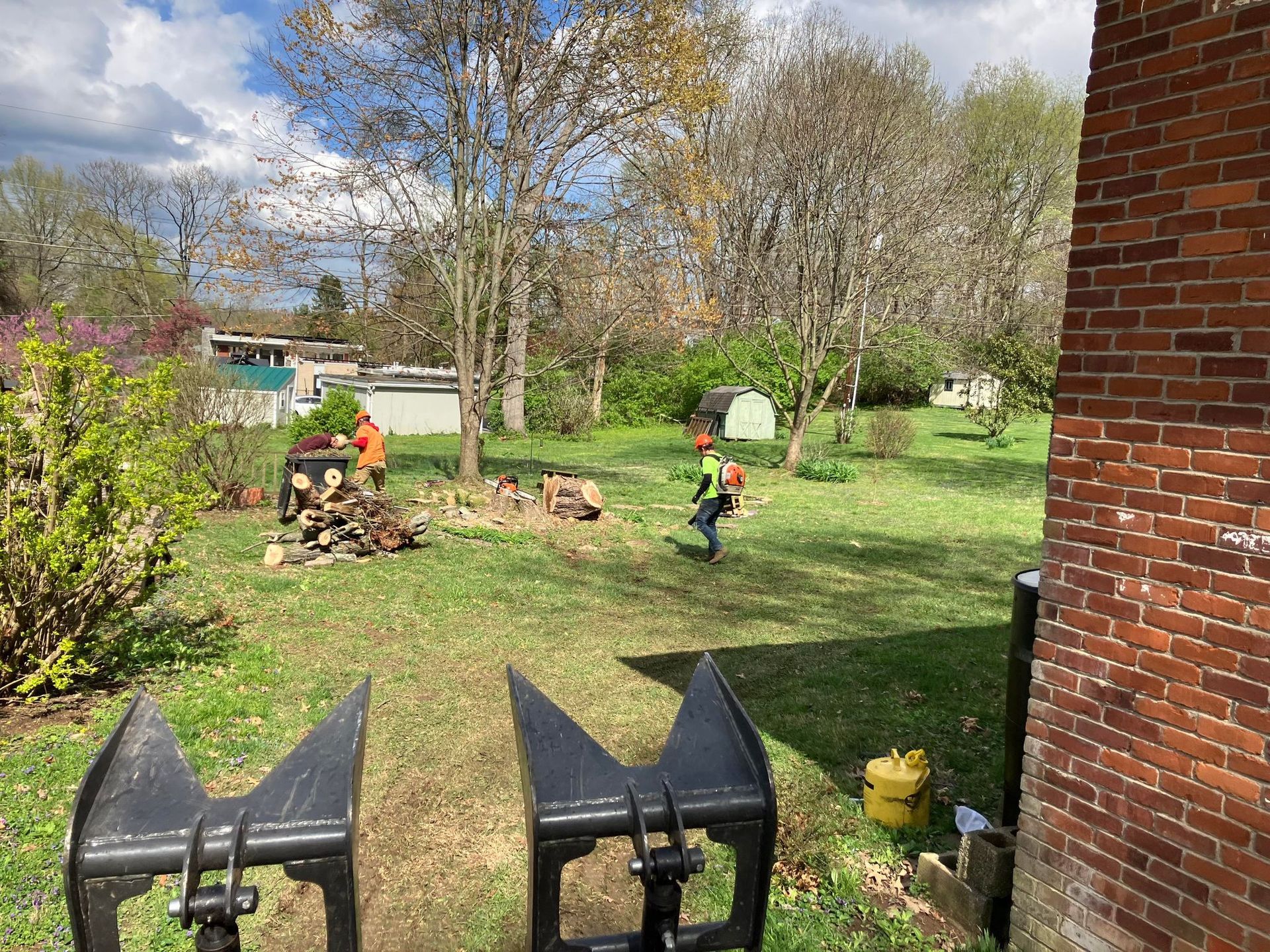 A brick building with a lawn mower in front of it