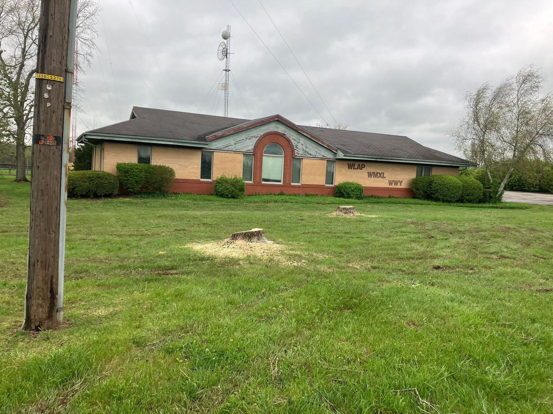 A house sits in the middle of a grassy field