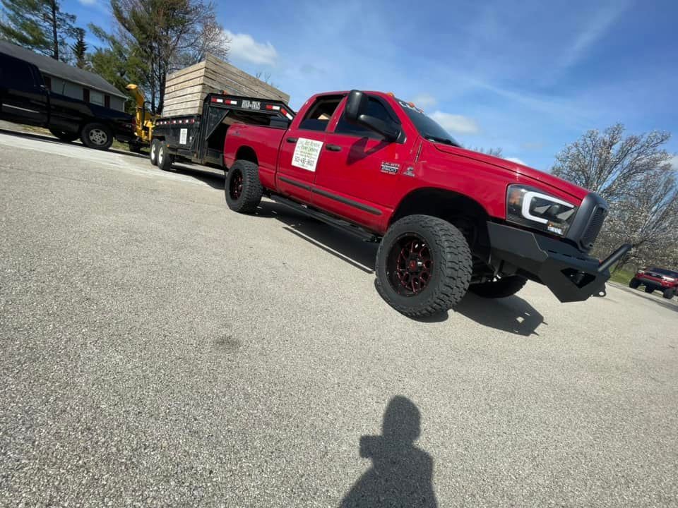 A red truck is parked on the side of the road