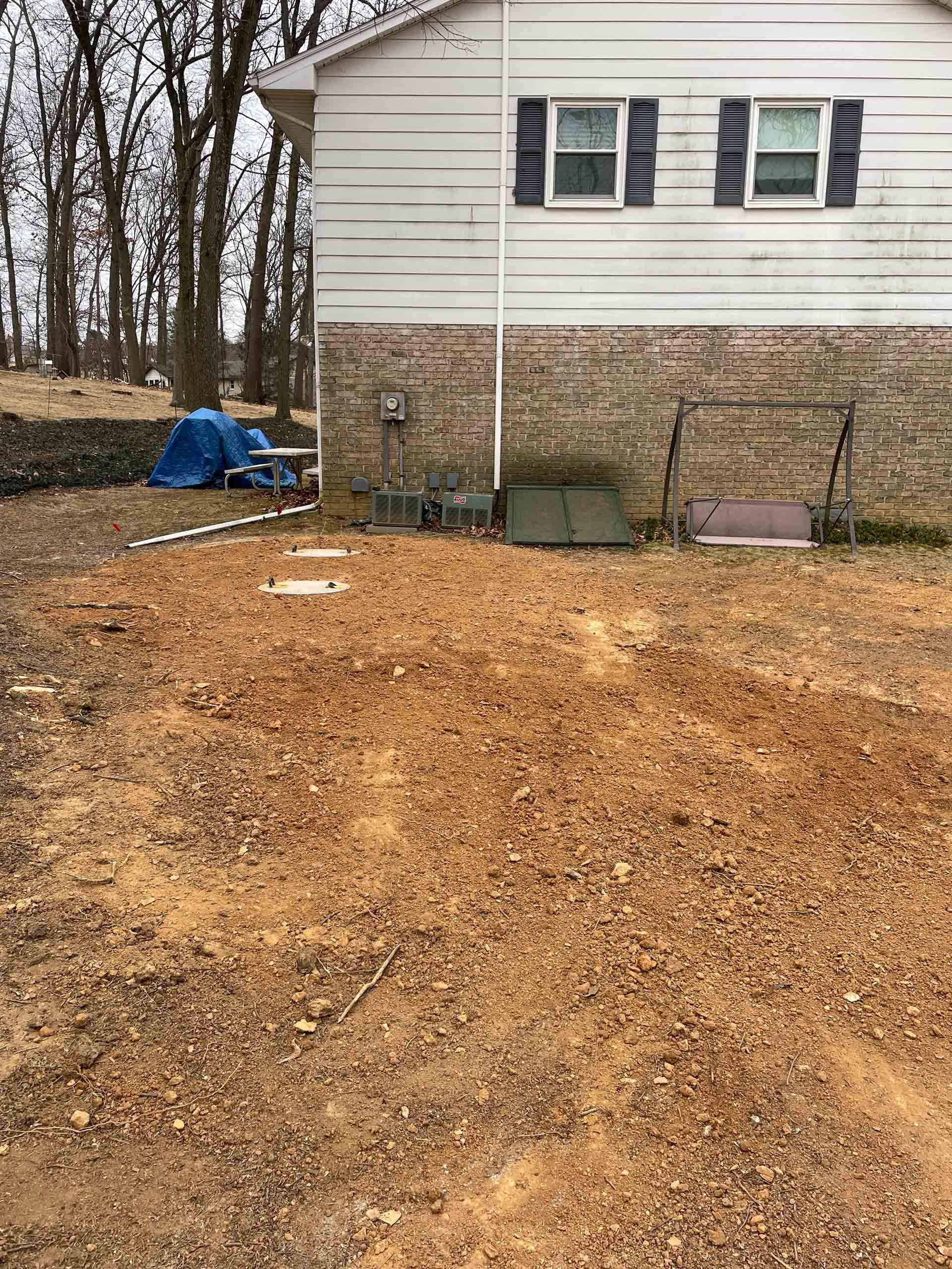 A house with a lot of dirt in front of it.