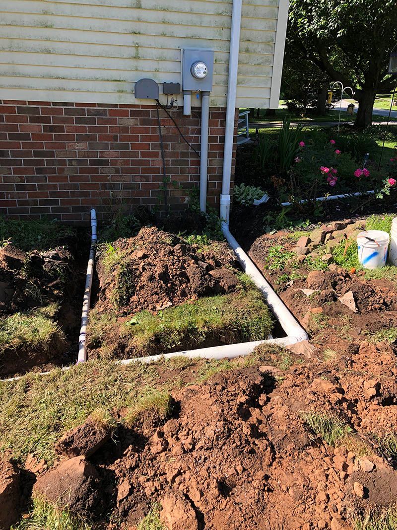 A pile of dirt is sitting in front of a house.