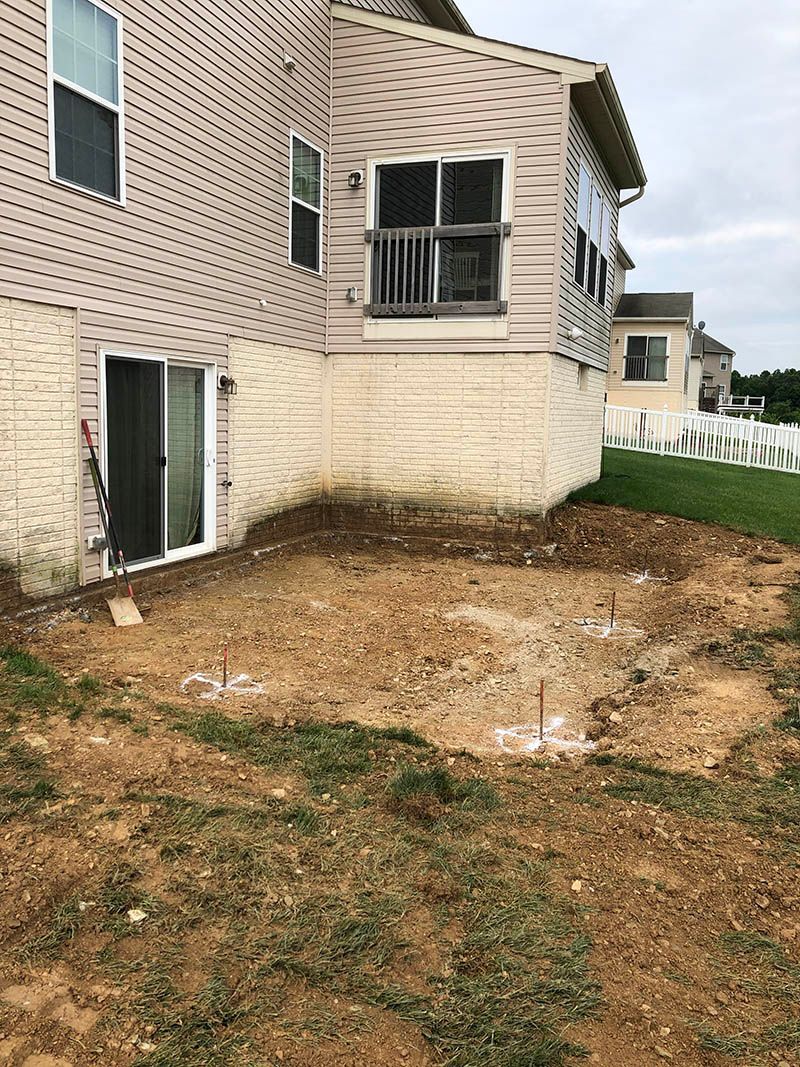 A house with a lot of dirt in front of it.