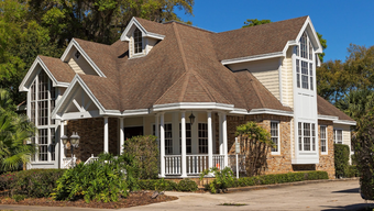 A large house with a brown roof and white trim