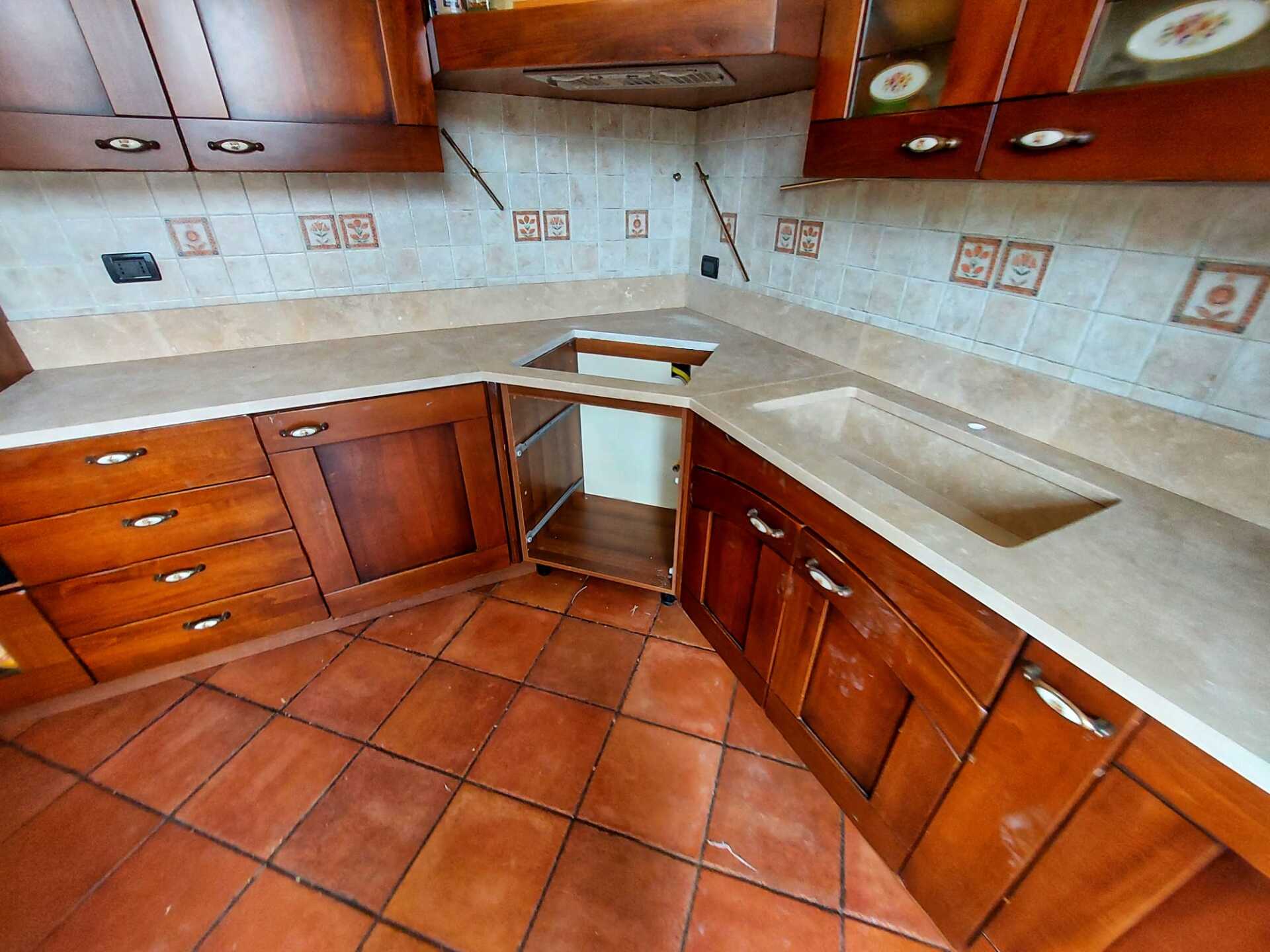 Una cucina con mobili in legno e un lavello