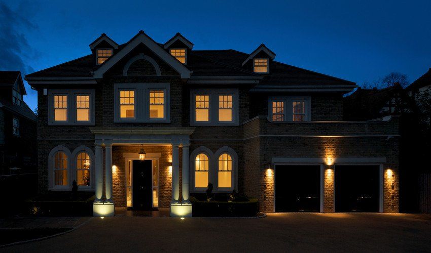Beautiful villa with wide backyard and decorative outdoor lighting, external view